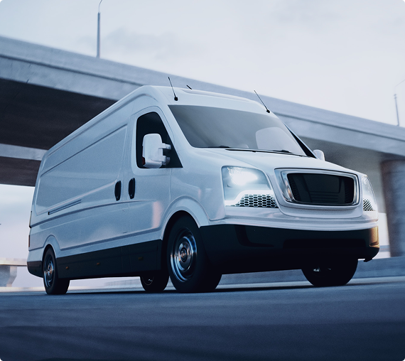 White cargo van parked outdoors near a modern building.