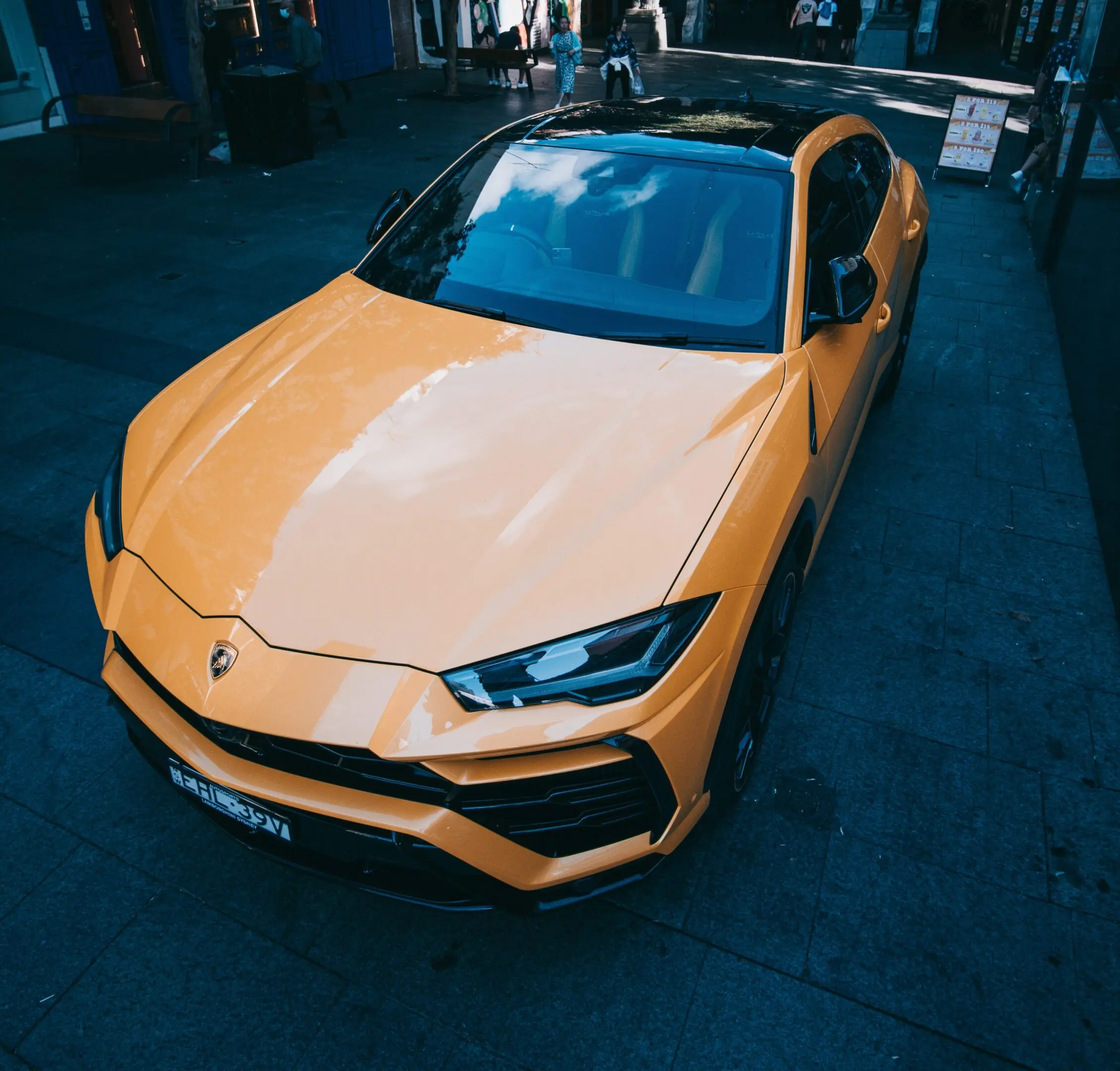 Sleek yellow Lamborghini parked on a city street at night.