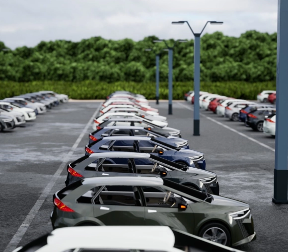 A parking lot filled with various parked cars on a cloudy day.